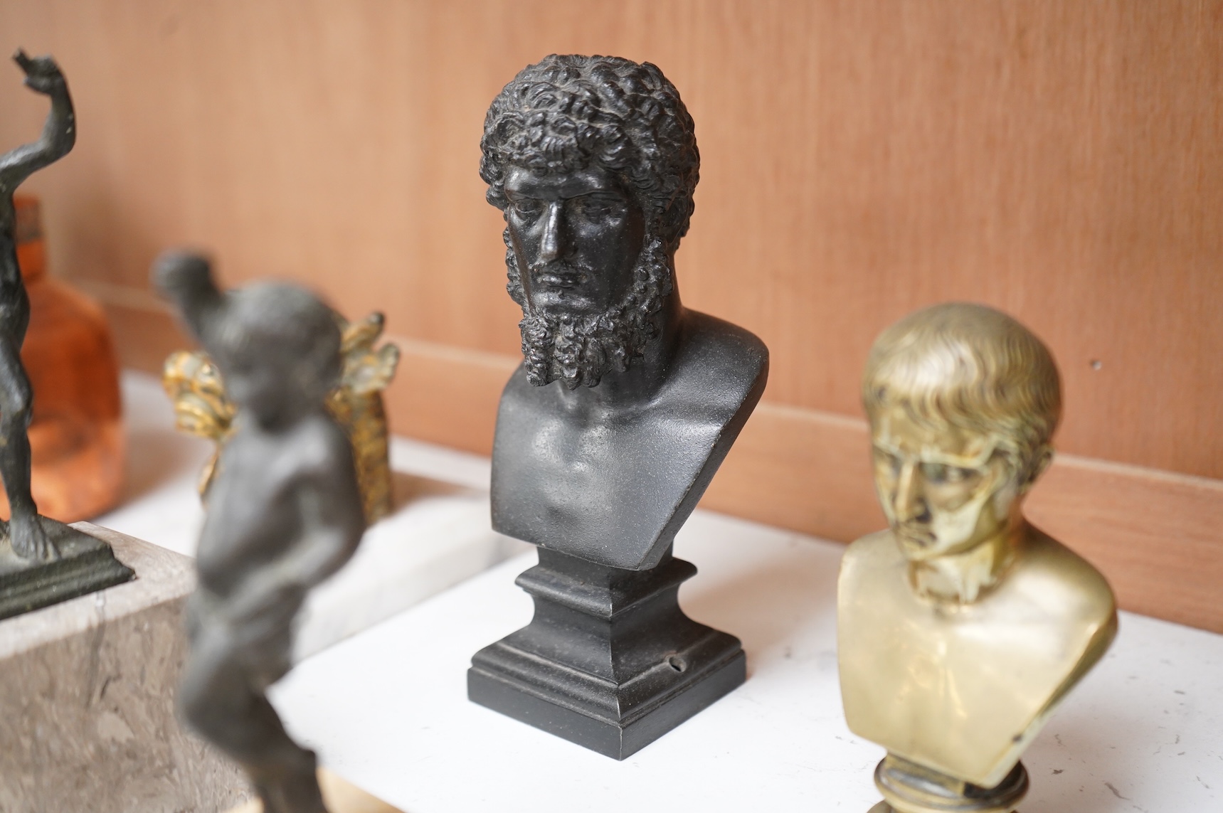 Italian grand tour souvenirs, 19th/20th century; nine small sculptures and busts, after the antique, the majority bronze and one depicting Lucius Verus, largest 19cm high